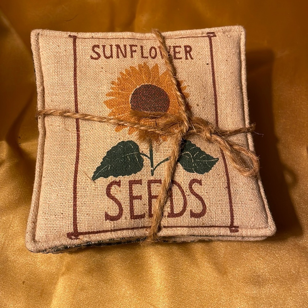 Fabric square coasters that say Sunflower seeds with a sunflower in the middle